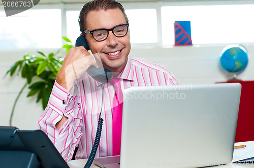 Image of Happy executive engaged on a business call