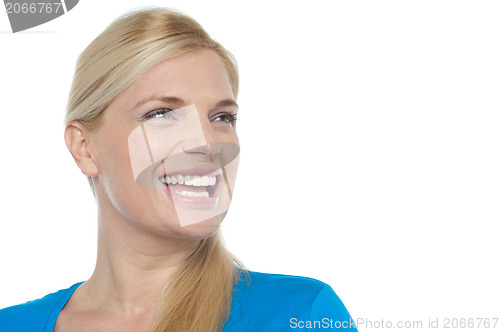 Image of Snap shot of a woman laughing while looking away