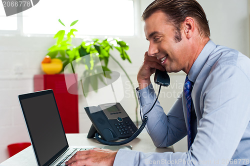 Image of Side profile of a businessman busy in office work