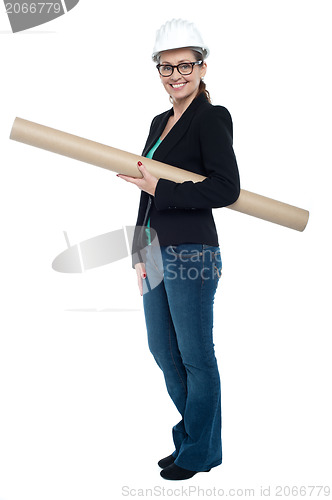 Image of Experienced female architect holding site blueprints