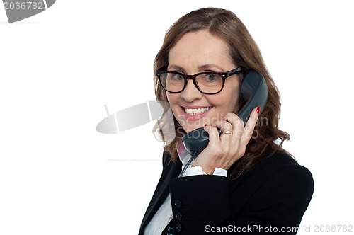 Image of Bespectacled woman talking over the phone