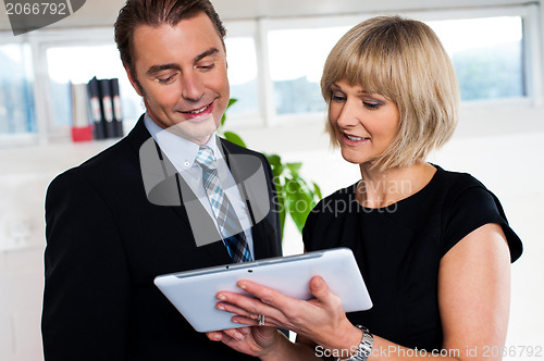 Image of Secretary with tablet pc discussing bosses schedule