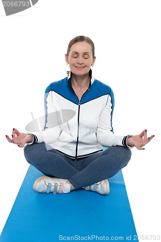 Image of Portrait of a woman sitting in a lotus position