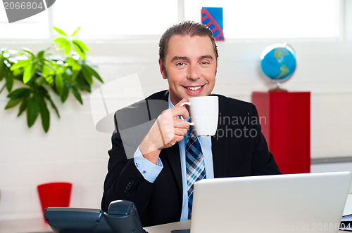 Image of Boss enjoying hot coffee during work break
