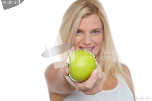 Image of Glamorous blonde offering you juicy green apple