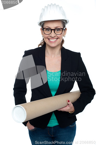 Image of Confident female architect carrying blueprints