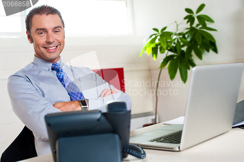 Image of Confident businessman at his workstation