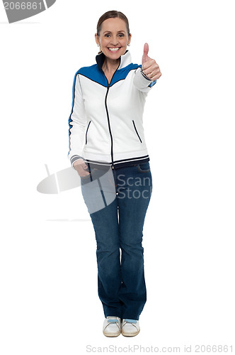 Image of Casual charming woman gesturing thumbs up