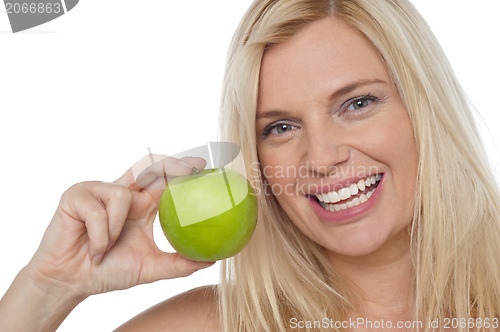 Image of Closeup shot of a cheerful woman holding an apple