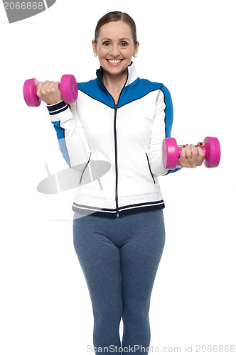 Image of Active woman posing with dumbbells