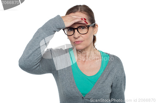 Image of Expressionless woman looking at distance object