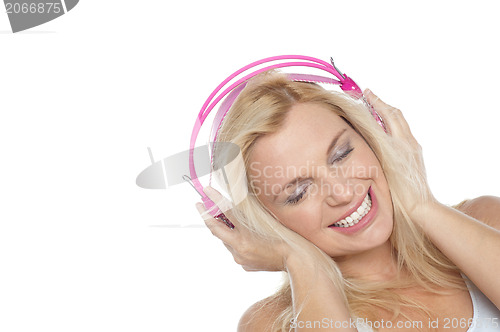 Image of Tilted shot of a blonde engrossed in music