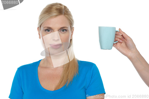 Image of Woman is being offered a cup of beverage