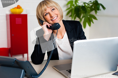 Image of Cheerful lady engaged in a jovial conversation