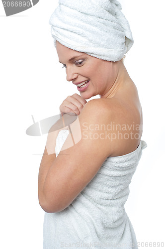 Image of Female wrapping herself in towel after hot spa