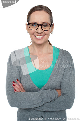 Image of Brunette with folded arms posing cheerfully