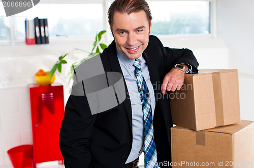 Image of Middle aged businessman at his relocated office