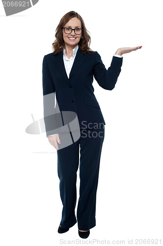 Image of Woman in business attire posing with an open palm