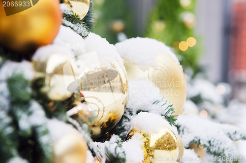 Image of Christmas fir tree decorated with balloons and is sprinkled with
