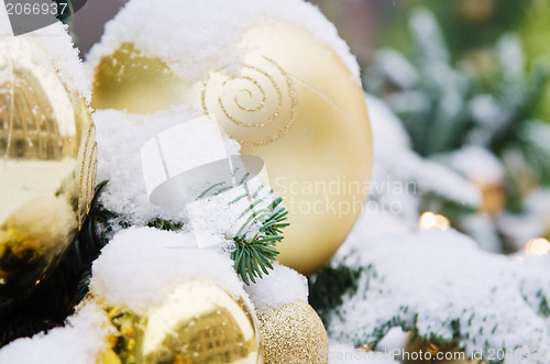 Image of Christmas fir tree decorated with balloons and is sprinkled with