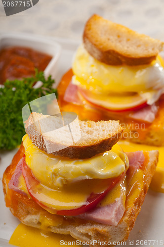 Image of eggs benedict on bread with tomato and ham