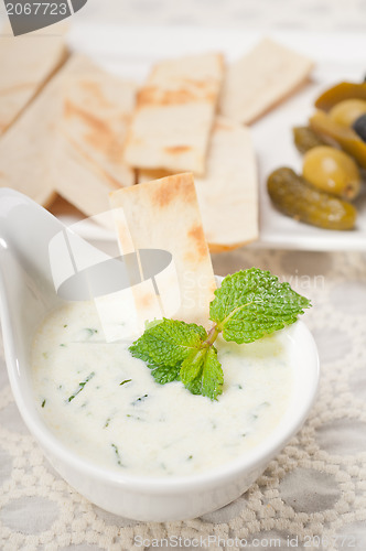 Image of Greek Tzatziki yogurt dip and pita bread