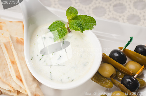 Image of Greek Tzatziki yogurt dip and pita bread