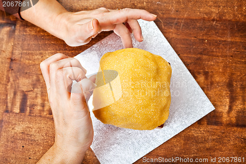 Image of Hands decorating christmas cake from above