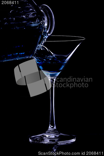 Image of Pouring a drink in the night