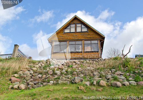 Image of wooden homestead house hill stone blue cloudy sky 