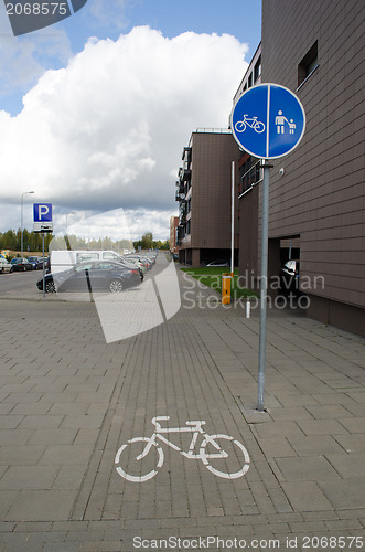Image of pedestrian bicycle sign way flat house car parking 