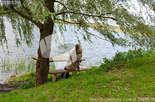 Image of woman sit wooden bench willow tree admire lake 