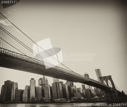 Image of Upward view of Brooklyn Bridge at Sunset with Manhattan Skyline