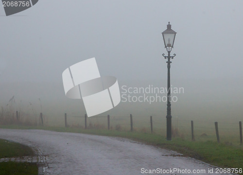 Image of Lantern at a misty road