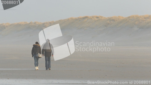 Image of Couple walking on a dutch beach