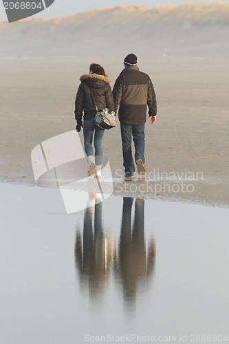 Image of Couple walking on a dutch beach