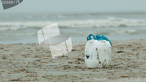 Image of Container with acid on a beach