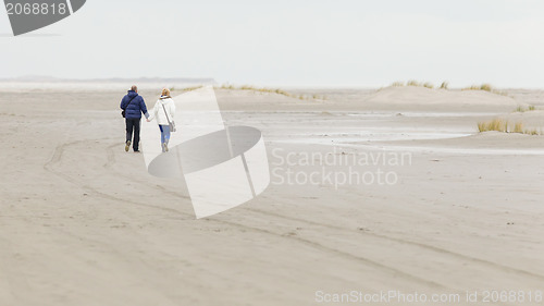 Image of Couple walking on a dutch beach