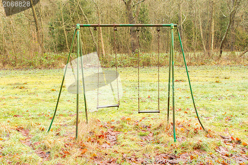 Image of Old rusted swing 