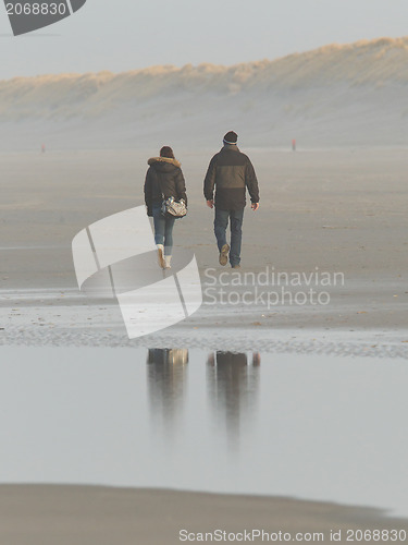 Image of Couple walking on a dutch beach