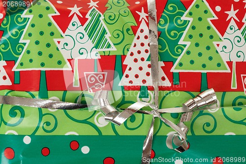 Image of detail of christmas gift with silver ribbon