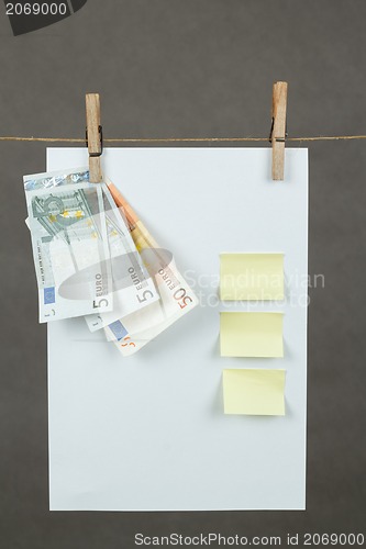 Image of Memory note paper with Euro moneys hanging on cord