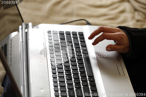 Image of Young woman working on laptop