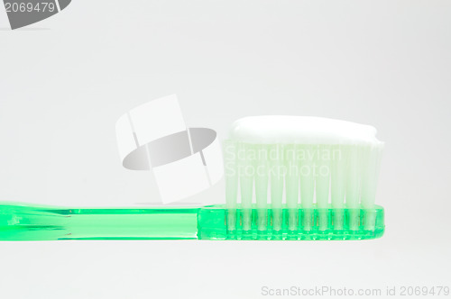 Image of green toothbrush isolated on white 
