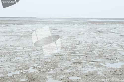 Image of Cracked earth on the sea background. 