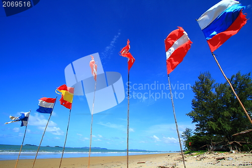 Image of  flags on white sand beach