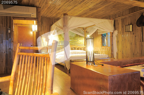 Image of Bedroom in a wood bungalow. 