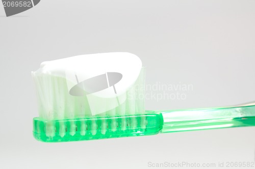 Image of green toothbrush isolated on white 