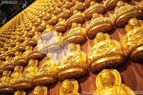 Image of Many small Buddha statue on the wall at chinese temple, Thailand 