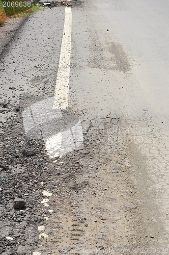 Image of closeup of cracks on asphalt road 